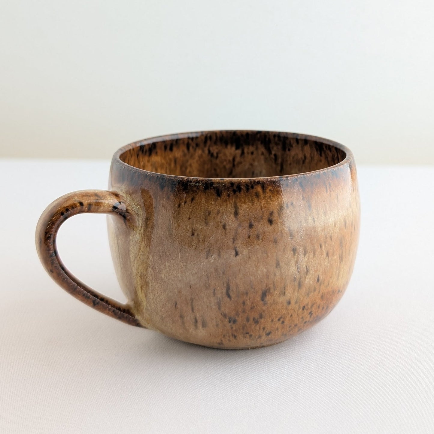 Brown ceramic mug on a white background